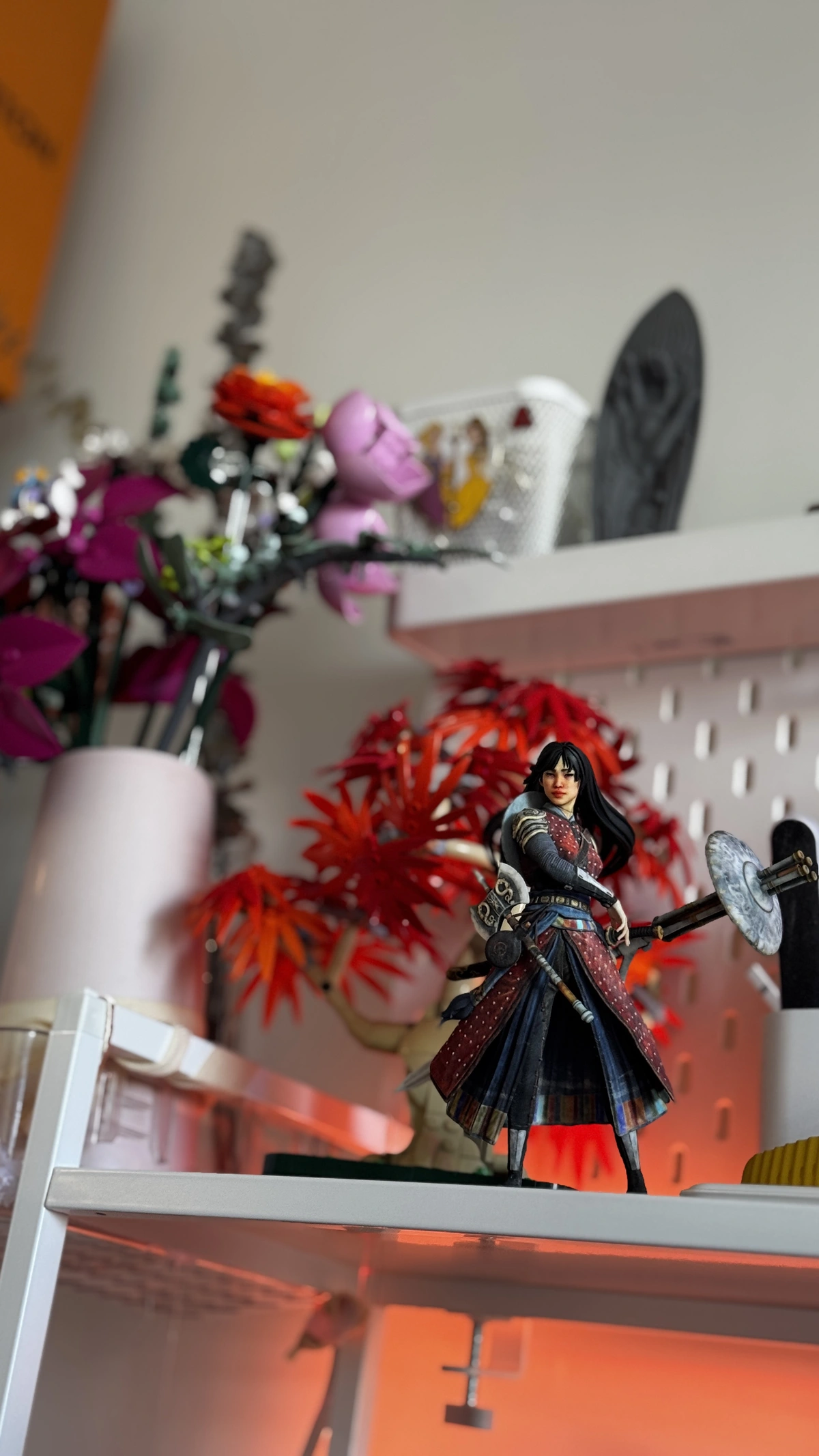 Dragon Warrior figurine displayed on a studio shelf with warm red lighting